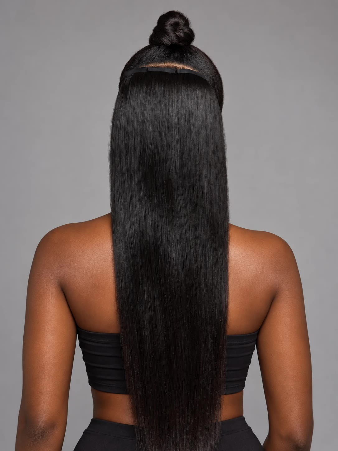 Model wearing straight tape-in extensions, back view